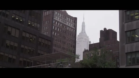 Low angle shot of empire state building in distance Stock Footage 57094374
