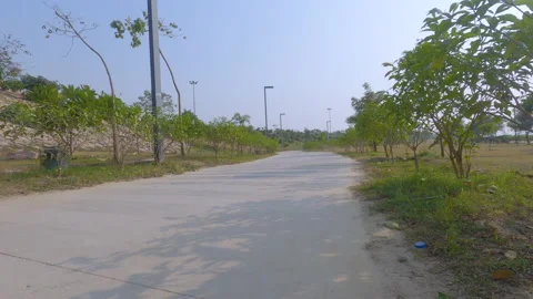 Low angle shot of an empty path road in a garden Stock Footage 146033566