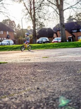 Low angle shot of empty surface with child cycling on the background Stock-Fotos