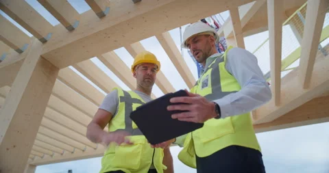 Low Angle Shot Engineer and Worker talk On Building Construction Stock Footage 326457772