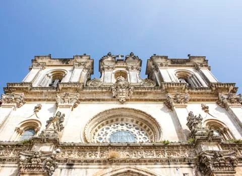 Low-angle shot of the facade of Alcobaca Monastery, or Mosteiro de Santa Maria Stock Photos