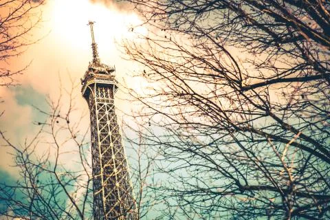 A low angle shot of the famous Eiffel Tower in Paris, France under a beautifu 스톡 사진