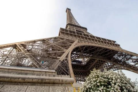 Low angle shot of the famous Eiffel Tower under a bright sky in Paris, France Stock Photos