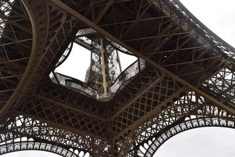 Low angle shot of the famous Eiffel tower in Paris against the cloudy sky during 스톡 사진