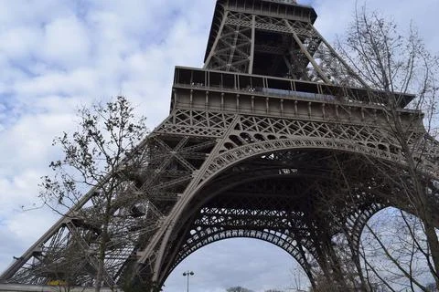 Low angle shot of the famous Eiffel tower in Paris against the cloudy sky during Stock Photos