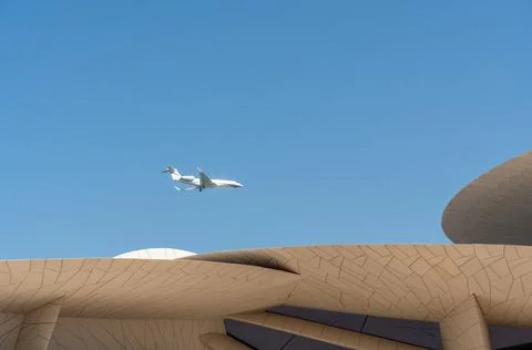 Low angle shot featuring A7-CHI Gulfstream G700 private jet flying over NMOQ. Stock Photos