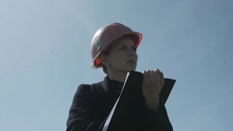 Low angle shot of female engineer fills in the data in the windmill Stock Footage 238009024