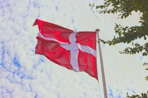 Low angle shot of the flag of Denmark dancing in the wind under the beautiful Foto stock