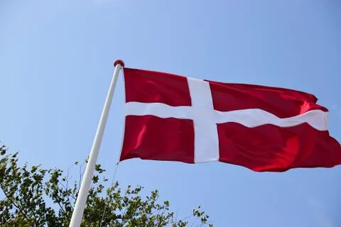 Low angle shot of the flag of Denmark dancing in the wind under the beautiful Foto stock