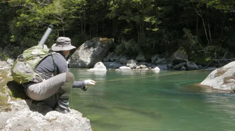 Low angle shot of an fly angler hooking a trout Video stock 64305695