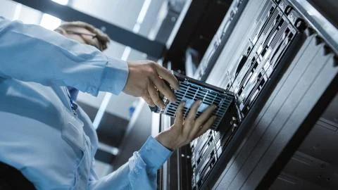 Low Angle Shot In Fully Working Data Center IT Engineer Installs Hard Drive i Stock Photos