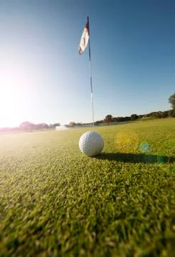 Low angle shot of golf ball on green Stock Photos