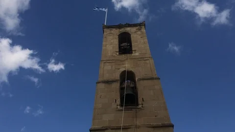 Low Angle Shot of Greek Flag waving on the top of belfry Stock Footage 99856320