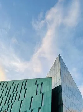 Low angle shot from ground. View of building corner against blue sky Stock Photos