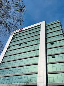 Low angle shot from ground. View of building corner against blue sky Stock Photos