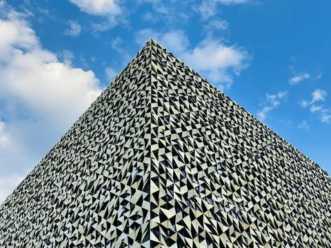 Low angle shot from ground. View of building corner against blue sky Stock Photos