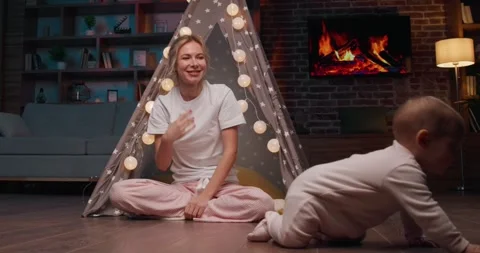 Low angle shot of a happy small child crawling on a floor at home. Video stock 242178603