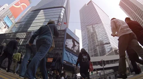 Low angle shot of heavy pedestrian traffic through intersection in Hong Kong Stock Footage 63474751
