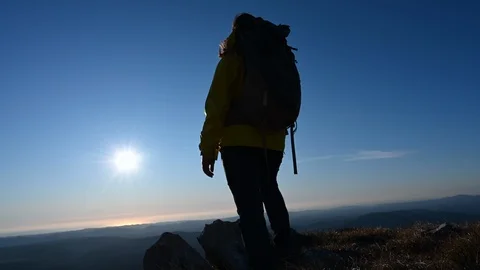 Low angle shot of a hiker walking to the edge on the mountain Stock Footage 124893807