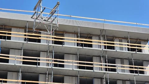 Low angle shot of hoisting down Staxo scaffolding structure with crane fork Vídeos de archivo 340157363