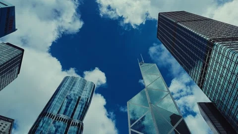 A low-angle shot of Hong Kong's towering skyscrapers against a vibrant blue sky 库存影片 338311535