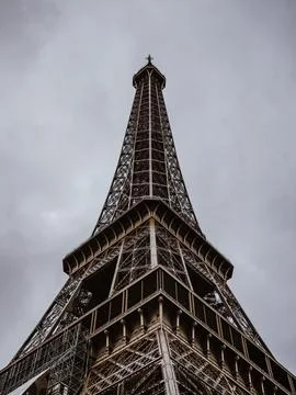 Low-angle shot of the iconic Eiffel Tower in Paris, France, against a backdrop o Photos
