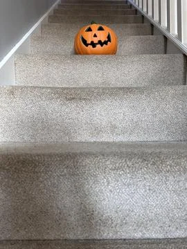 Low angle shot of jack-o-lantern halloween pumpkin on top of the staircase Stock Photos
