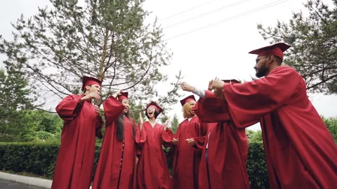 Low angle shot of joyful men and women graduating students throwing mortar Stock-Footage 91835359