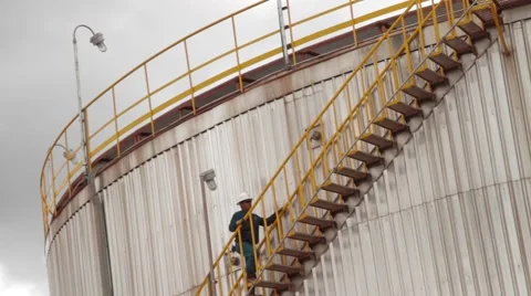 Low Angle Shot of a large-sized tank at an oil and gas facility Stock Footage 45236942