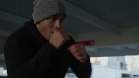 Low angle shot of a Latino boxer exercising in a garage Stock-Footage 153344359