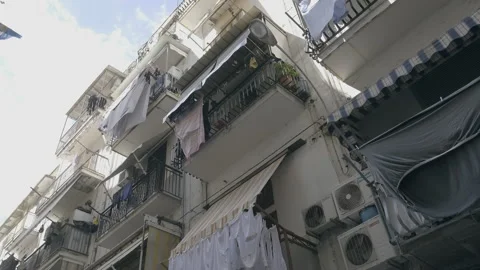Low angle shot of laundry hanging from balconies. Stock Footage 169468782