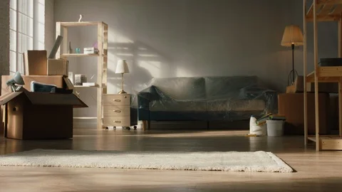 Low-angle shot of legs of a couple spinning around their new home, happy about Video stock 127546208