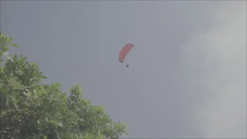 Low angle shot in Lima of a hang glider in Miraflores District, Peru LOG Stock Footage 310939013