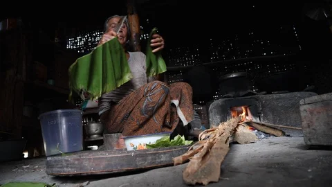 Low angle shot of local Balinese woman preparing banana leaf rolls, Bali Stock Footage 140255106