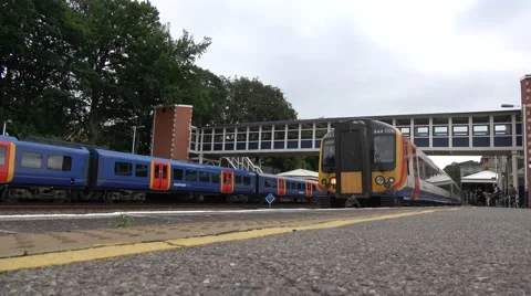 Low angle shot of a london bound commuter Train pulling into station Stock Footage 66158272
