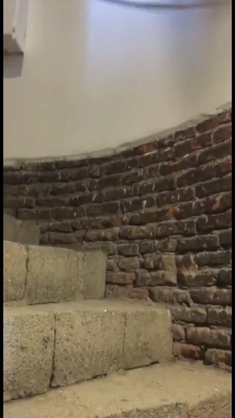 Low-angle shot looking up at a circular brick staircase inside a historic 動画素材 333376771