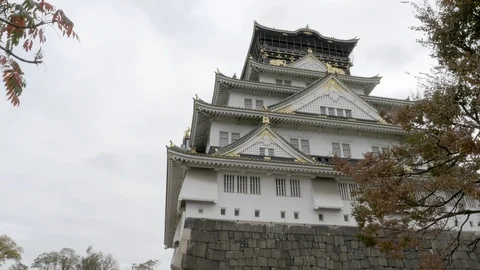 Low angle shot looking up at Osaka Castle in Osaka, Japan. Slow pan right. 스톡 동영상 115386651
