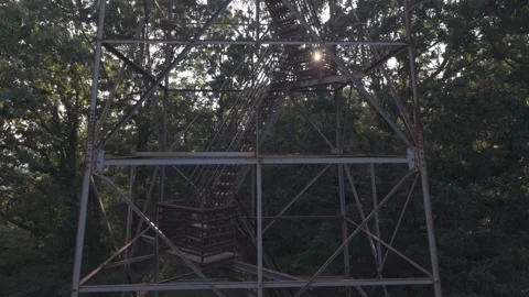 Low Angle Shot Looking Up Steel Fire Lookout Tower Against Dusk Sky A dramatic Stock Footage 342243998