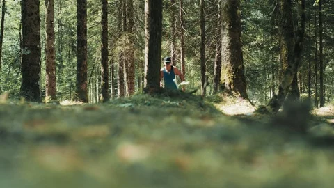 Low Angle Shot Of A Man Running On Soft Mossy Ground In The Coniferous Forest Stock Footage 94031910