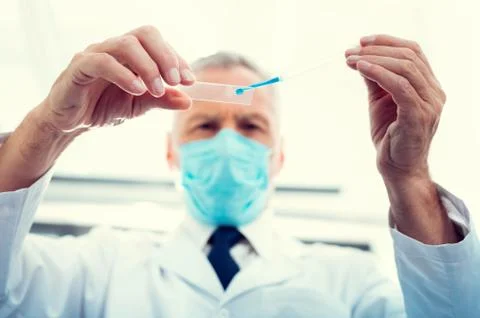 Low angle shot of man sampling chemical liquid Stock Photos