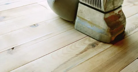 A low angle shot of a man sanding a parquet with a parquet sanding machine Stock Footage 55327922