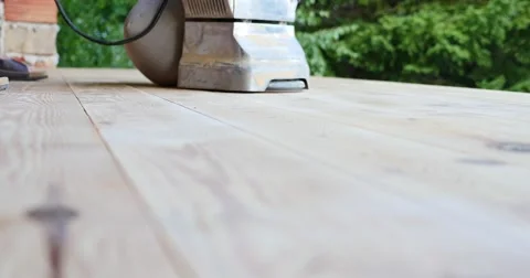 Low angle shot of a man sanding a parquet with a parquet sanding machine Stock Footage 55327945