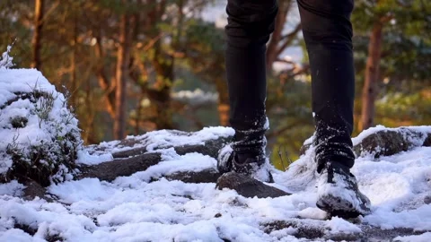 Low angle shot of man walking down snowy mountain Stock Footage 233514053