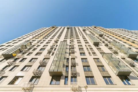 Low angle shot of a modern high rise office building against a blue sky during d Fotos de archivo