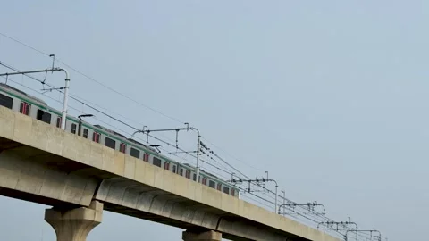 Low angle shot of a modern metro transit train moving on an elevated concre.. Stock Footage 337582911