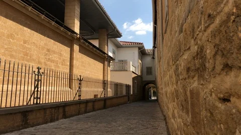 Low Angle Shot on a Narrow Path Between Old Buildings Stock Footage 101381380