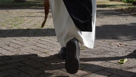 Low angle shot of nun walking outdoor in traditional clothes Stock Footage 128397775