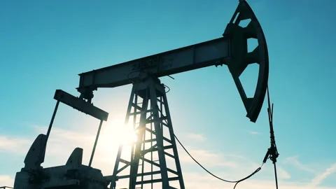 Low angle shot of oil pumpjack operating against blue sky Stock Footage 141495061