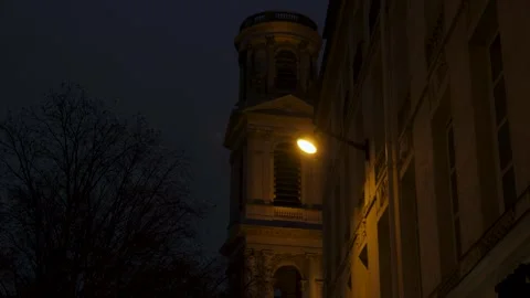 Low-angle shot of one tower of Saint-Sulpice Church glowing at night Stock Footage 319246971