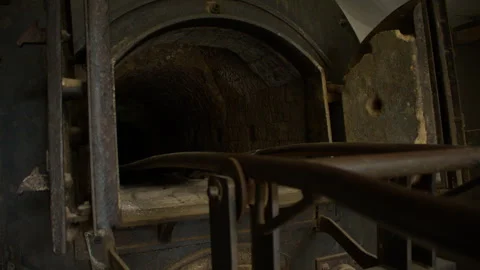 Low angle shot of an open chamber in old crematorium furnace with heavy rust Stock Footage 299052805